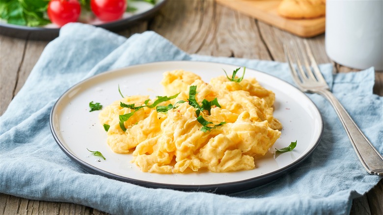 Soft scrambled eggs on white plate 