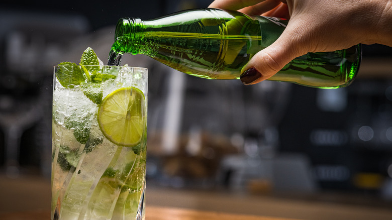 Seltzer poured into cocktail