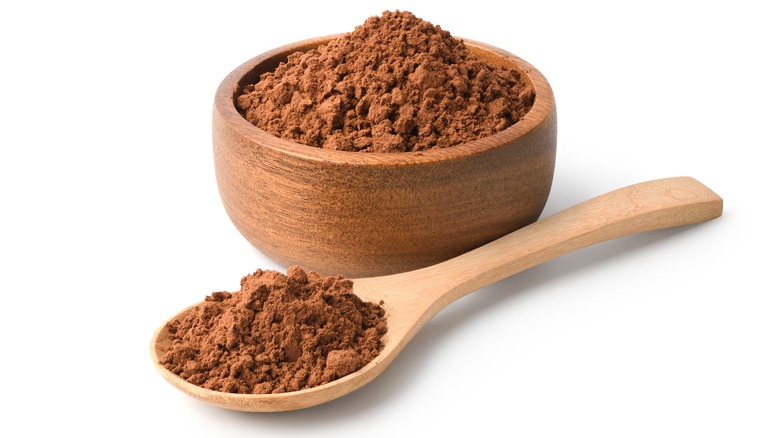 Cocoa powder in bowl and spoon