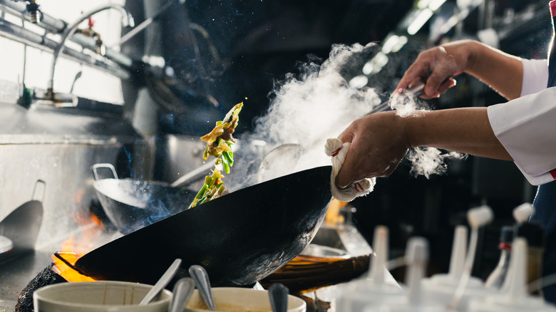 Chef flips smoking pan