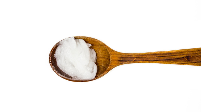 Wooden spoon of coconut oil