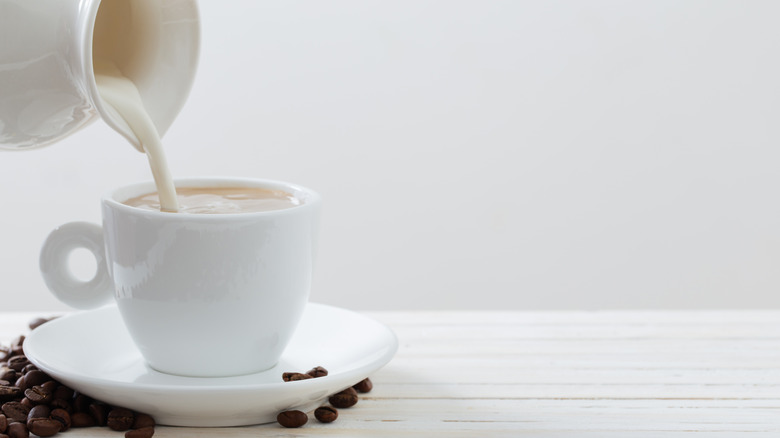 Coffee creamer being poured into cup