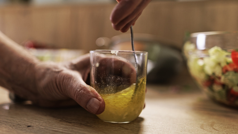 person mixing a vinaigrette