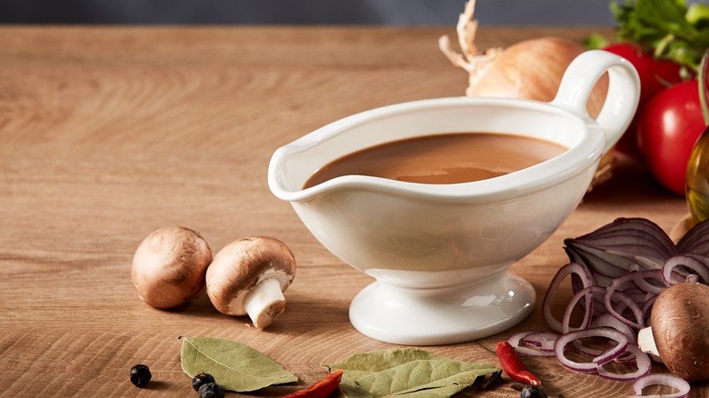 Gravy boat surrounded by vegetables