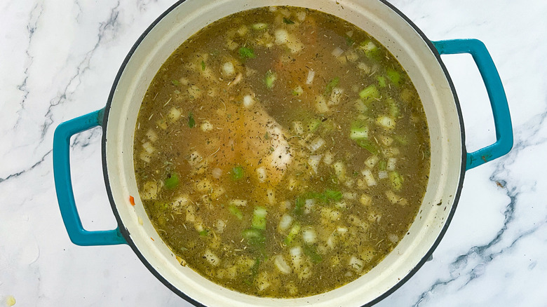 vegetables, broth, chicken in pot