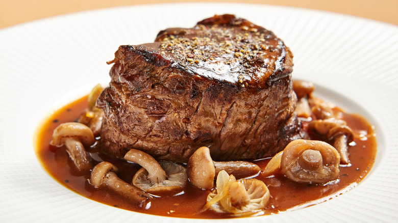 Steak with mushrooms on plate