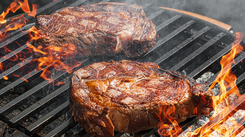 Steaks being grilled on barbecue