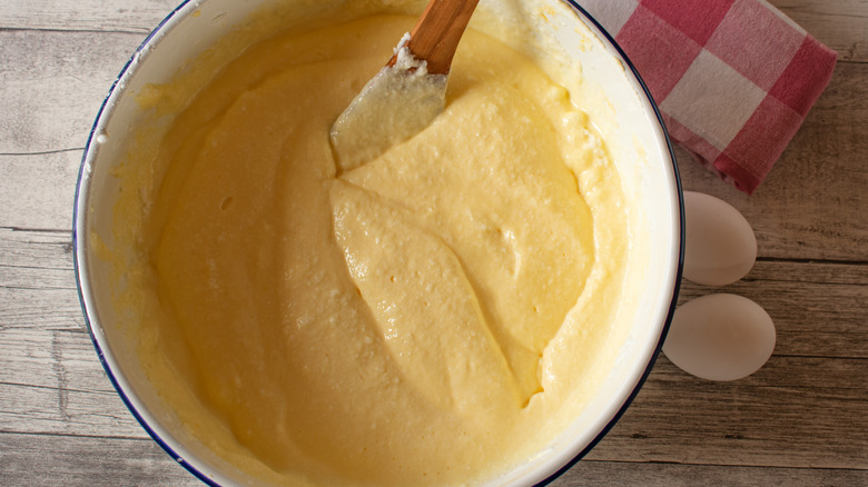 cake batter in bowl with wood spoon