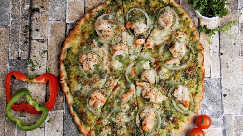 Pesto Alfredo shrimp pizza on bricks