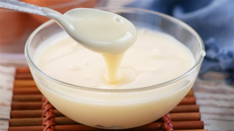 Bowl of condensed milk with spoon 