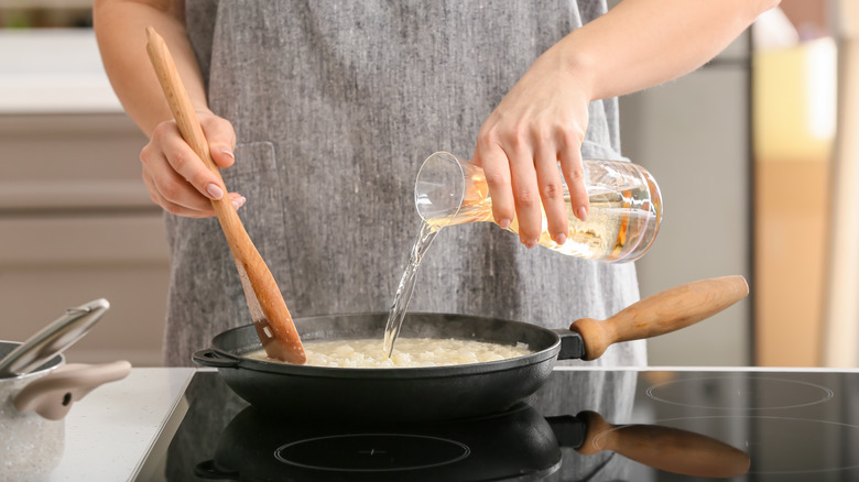 Woman cooking risotto on stovetop