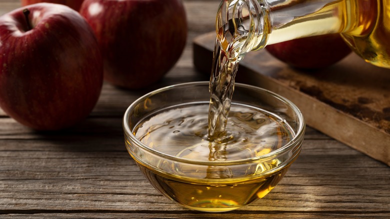 pouring vinegar into a small glass bowl