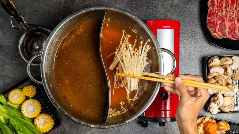 Using chopsticks cooking in pot