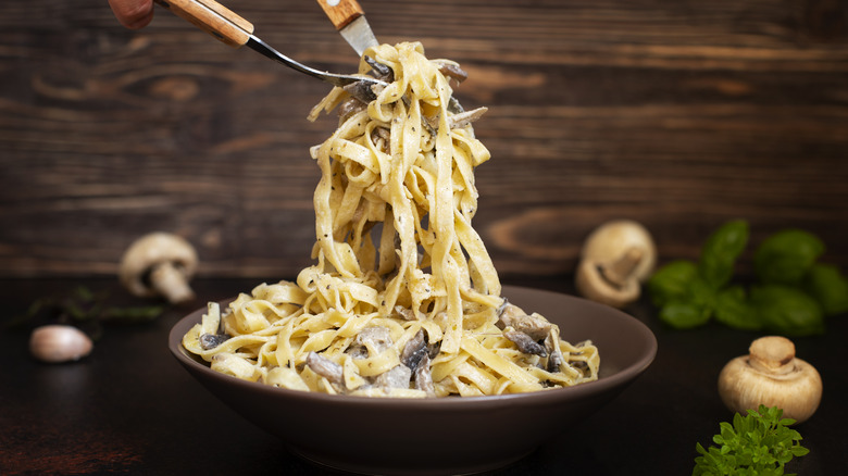 A creamy dish of fettucine pasta with mushrooms.