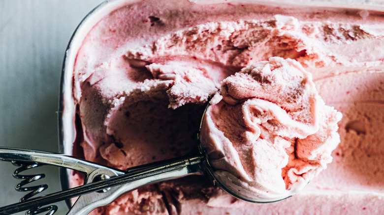 scooping strawberry ice cream