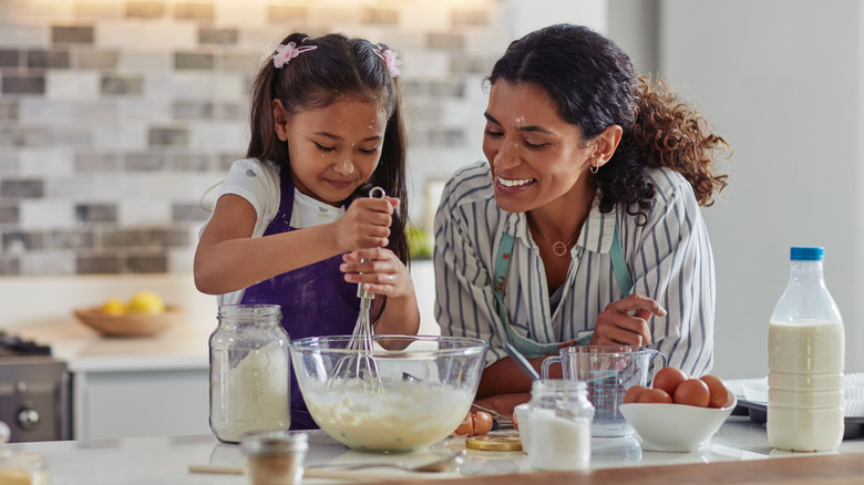 Mom and daughter making batter