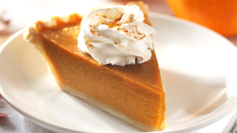 Pumpkin pie slice with whipped cream 