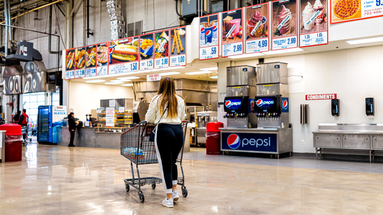 woman approaching Costco prepared foods counter