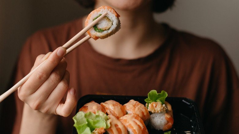 person eating sushi