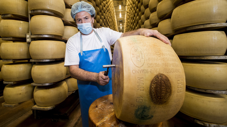 cheesemaker with Parmigiano Reggiano wheel