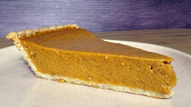 Pumpkin pie slice on plate