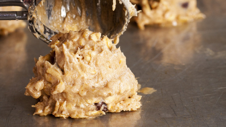 Cookie dough being scooped onto baking tray