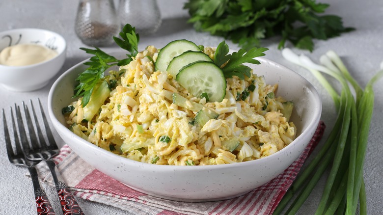 Bowl of egg salad with chicken and cucumber