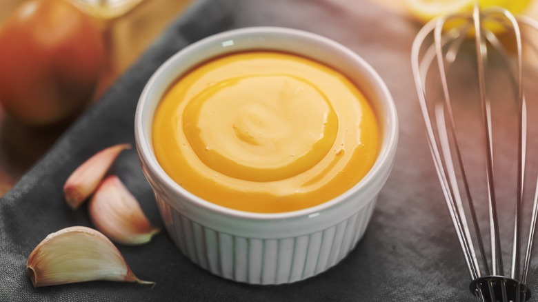 Aioli in ramekin with whisk