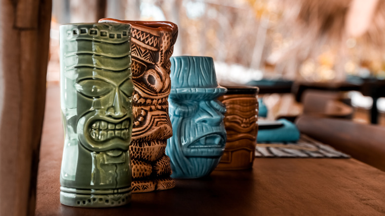 decorative Tiki cocktail glasses on restaurant table