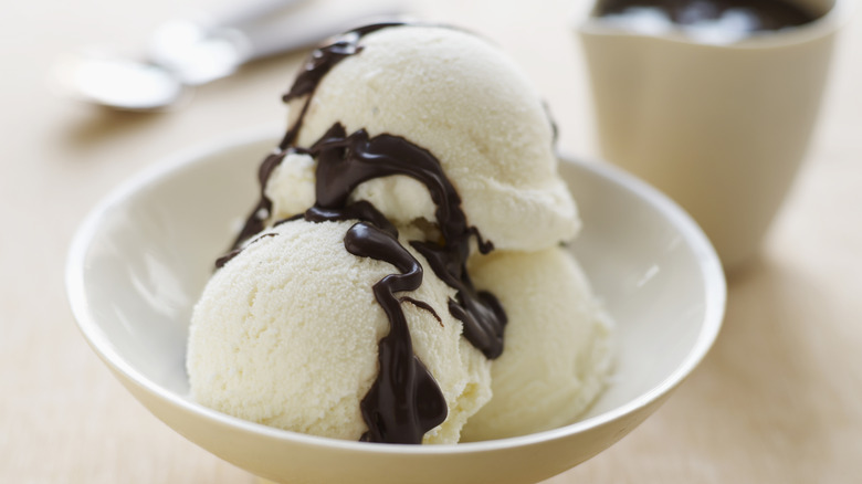 Scoops of vanilla ice cream with chocolate on top