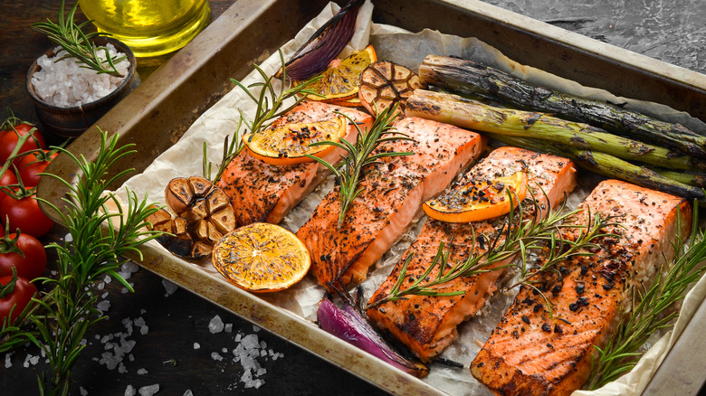 baked salmon filets in a pan with aromatics