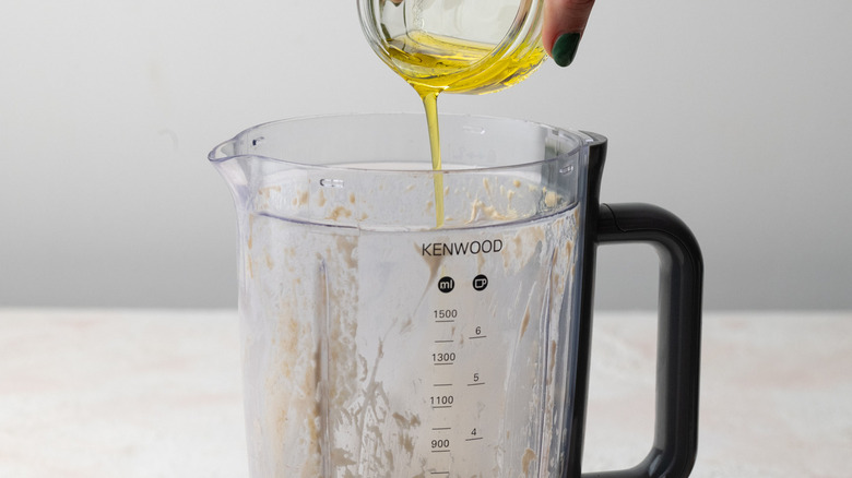 pouring oil into blender