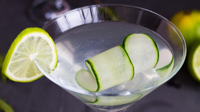 martini close up with cucumber and lime garnish