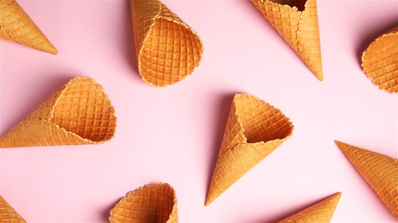 Empty waffle cones on pink background 