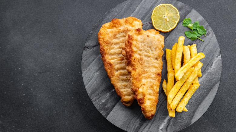 Breaded fish on round slab