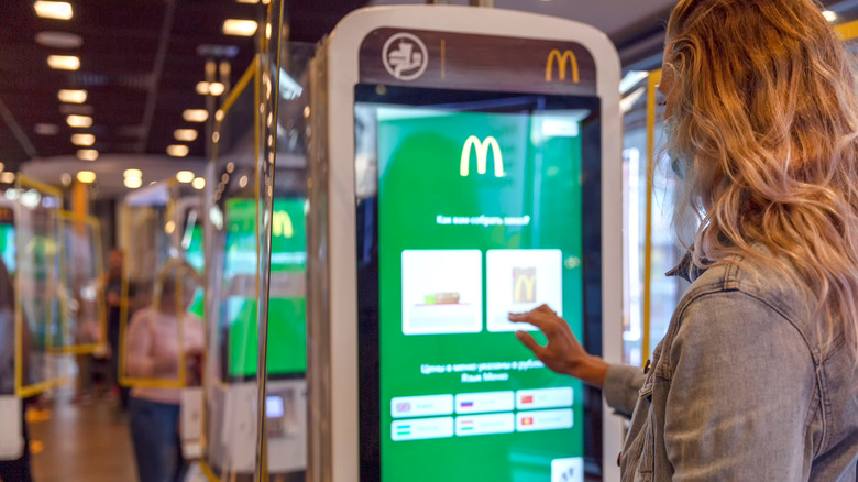 Woman ordering from a kiosk in a restaurant