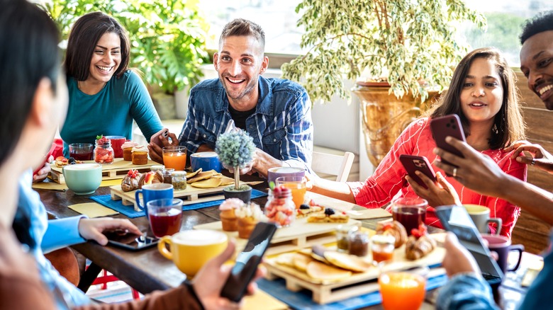 people eating brunch, laughing, and talking