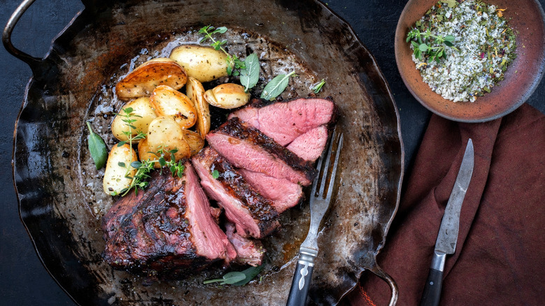 roast boar with potatoes on plate