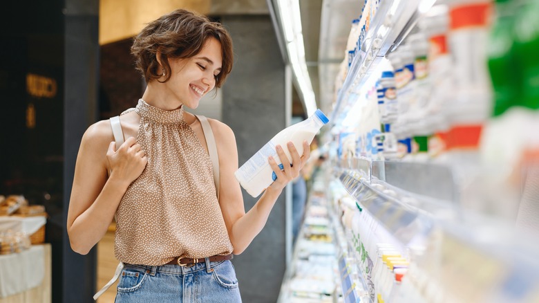 Woman happily shopping for milk