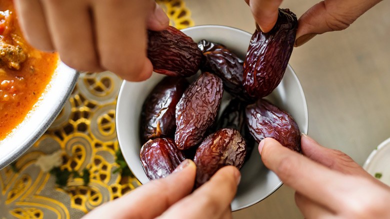 Group of people eating dates 