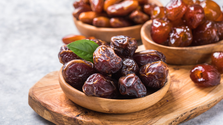 Date palm fruits in a wooden bowl