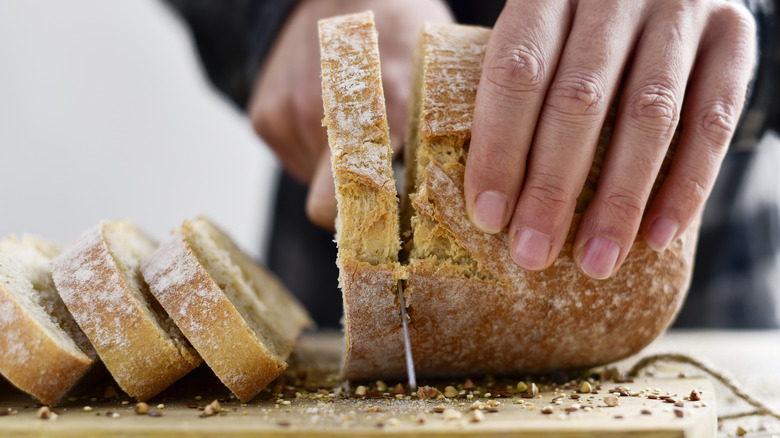 slicing loaf of fresh bread