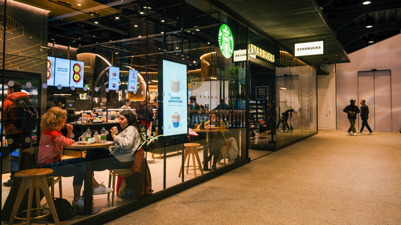 Starbucks store with guests sitting at tables