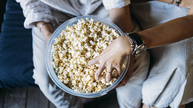 hand in Bowl of popcorn