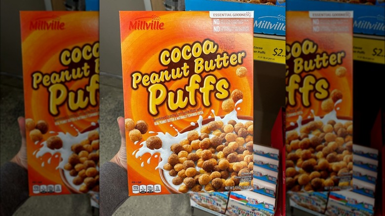 holding up box of aldi cocoa peanut butter puffs