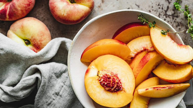 bowl of half and sliced peaches