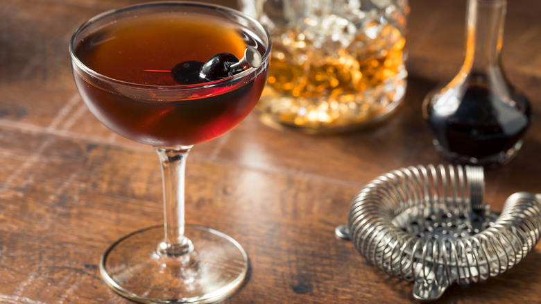 Manhattan in a cocktail glass with cherry garnish