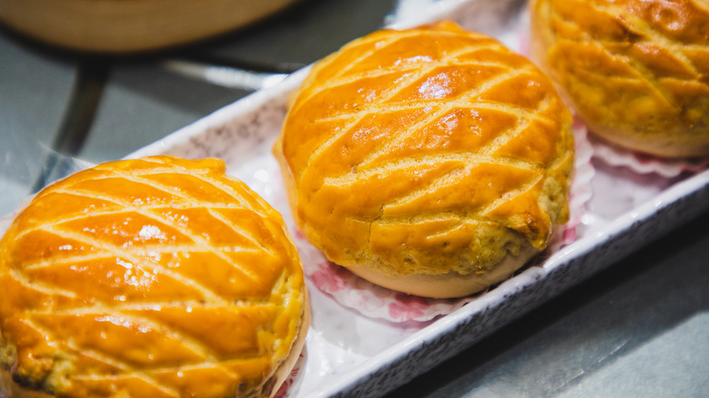 Three pineapple buns on a plate