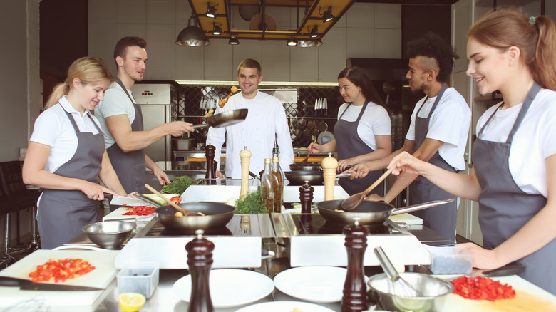 culinary students cooking with instructor