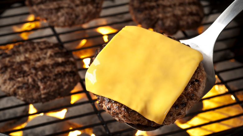 Burger on grill about to be flipped